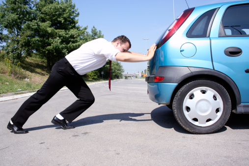 Businessman pushing a car