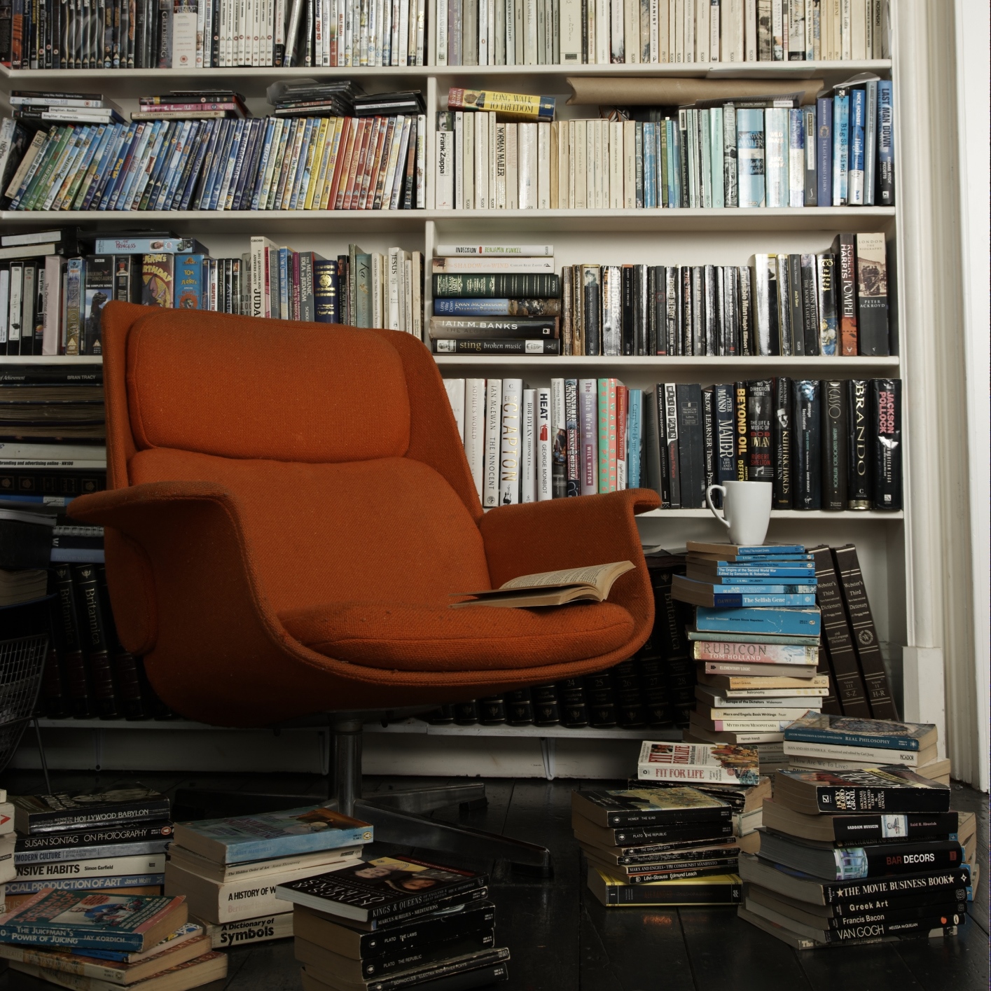 comfortable chair surrounded by books