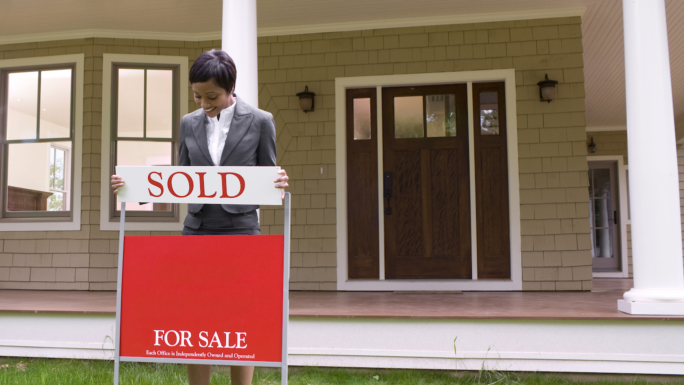 Realtor with sale sign