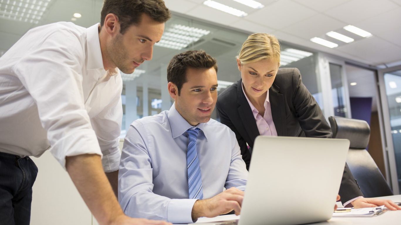 Business team of three in office and planning work