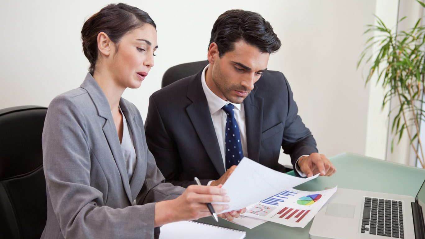 Sales persons working with a notebook