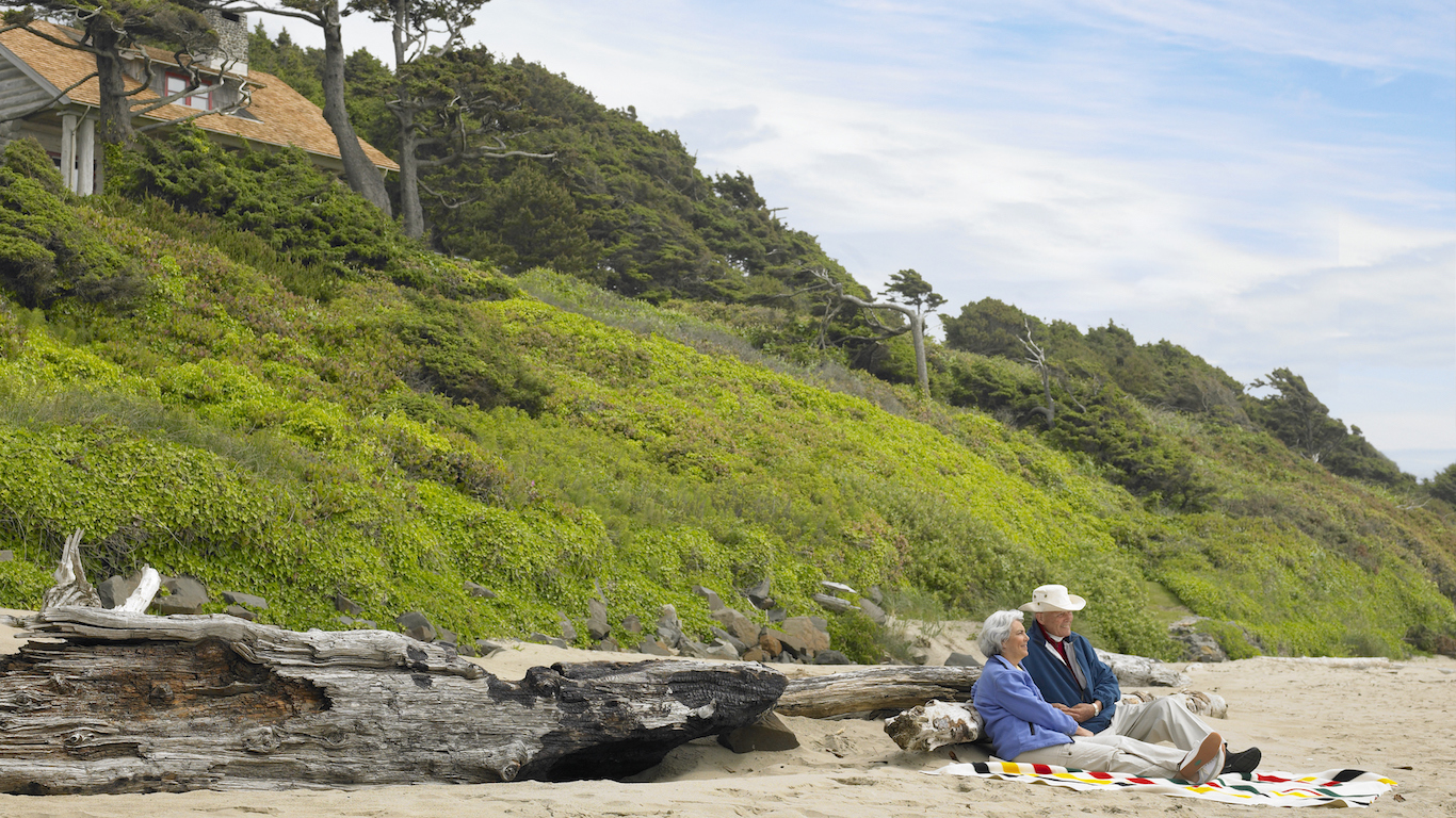 Oregon old couple sitting on the beach