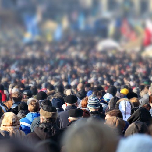 Crowd of anonymous people on street in city center