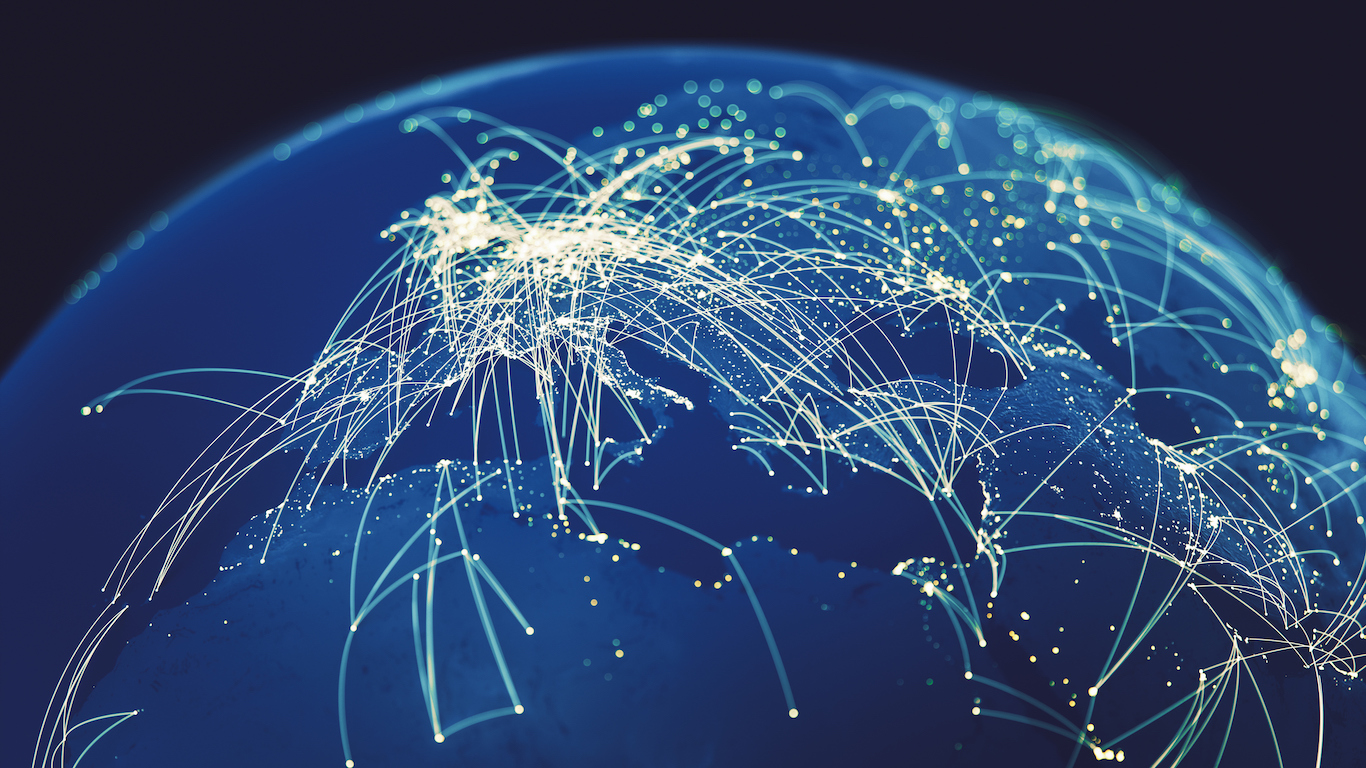 A dark blue globe featuring numerous bright white lines and illuminated dots connecting various regions, predominantly Europe and parts of Africa and Asia, illustrating a vast global network against a dark background.