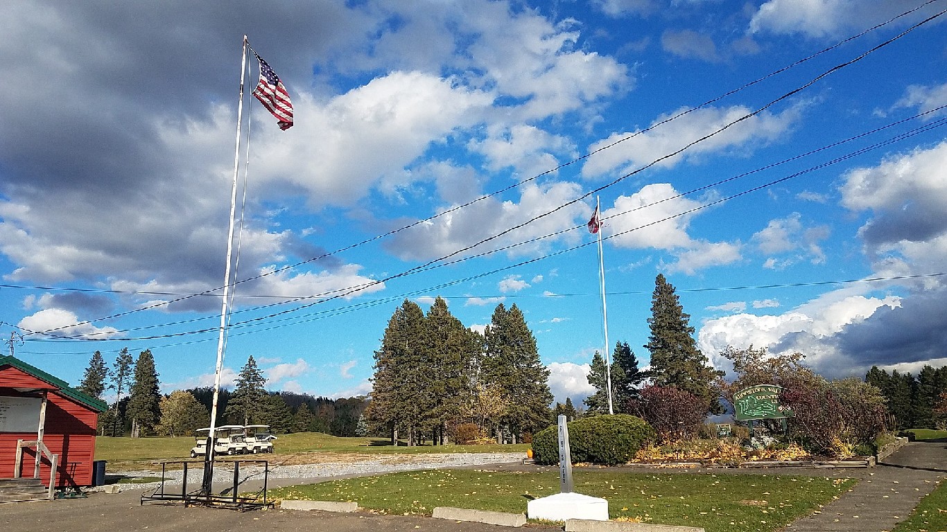 Aroostook Valley Country Club entrance showing US and Canadian flags and border marker by Shanghai88