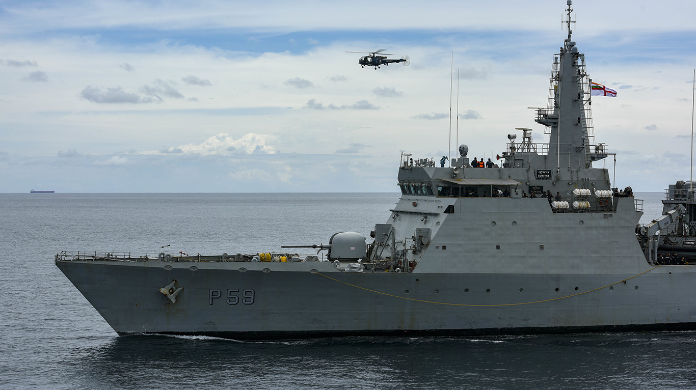 INS Sumitra (P59) with a Chetak helicopter during a passex with USS Russell (DDG 59) by Shashpant