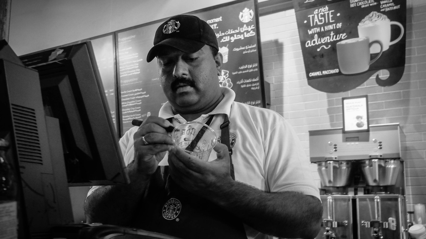 Starbucks barista writing on Frappuccino cup