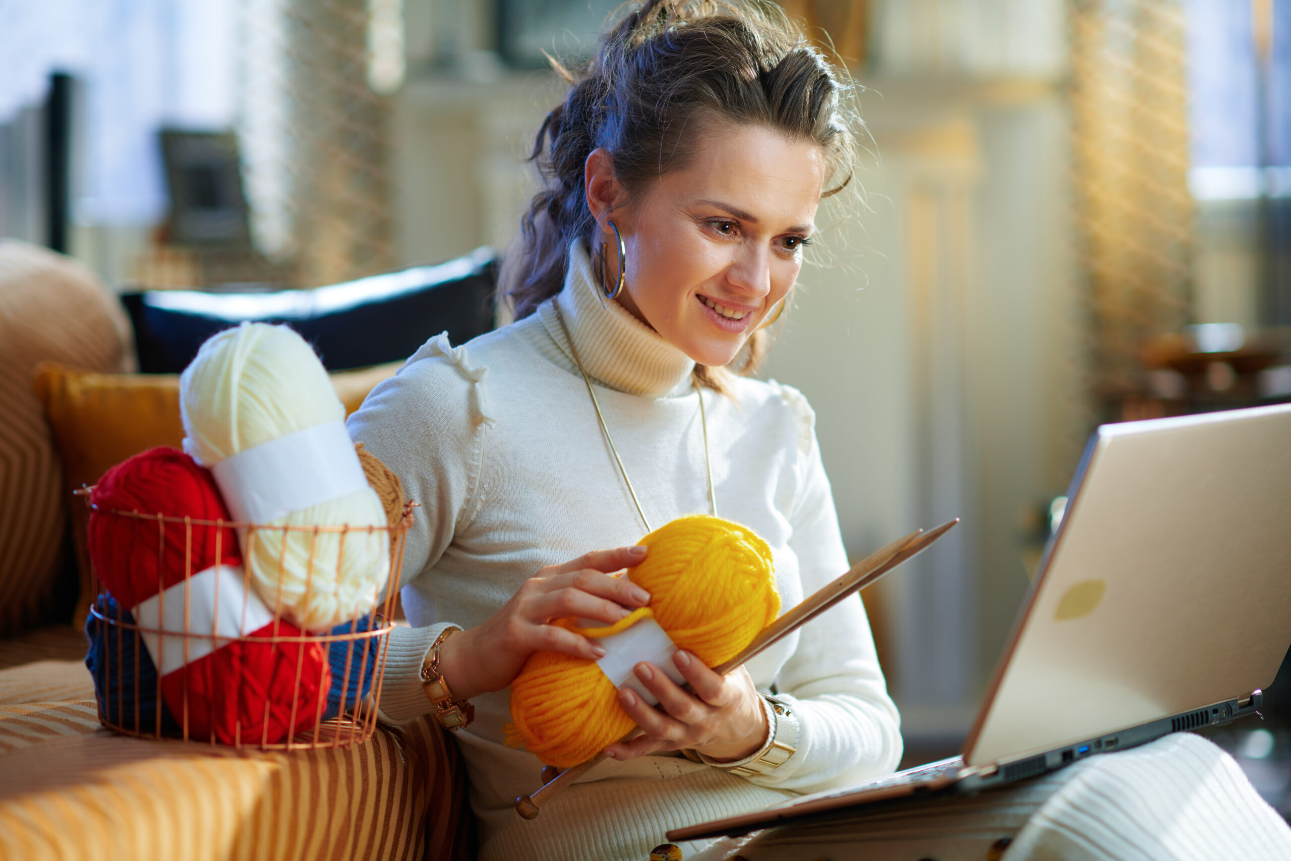 smiling elegant woman with yarn learn how to knit