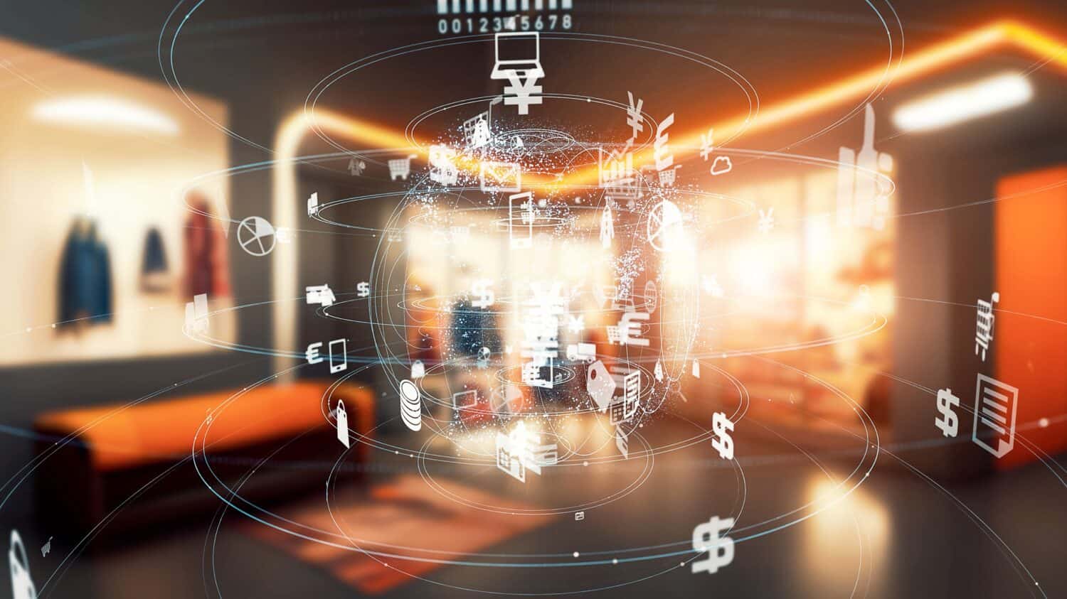 A brightly lit, modern office interior with a large, glowing, translucent sphere in the center. The sphere is composed of many interconnected lines and is covered in white, glowing icons representing currency symbols (Yen, Euro, Dollar), shopping carts, laptops, graphs, mail, phones, and other business-related motifs. The background shows blurred office furniture, including an orange bench and clothes on hangers.