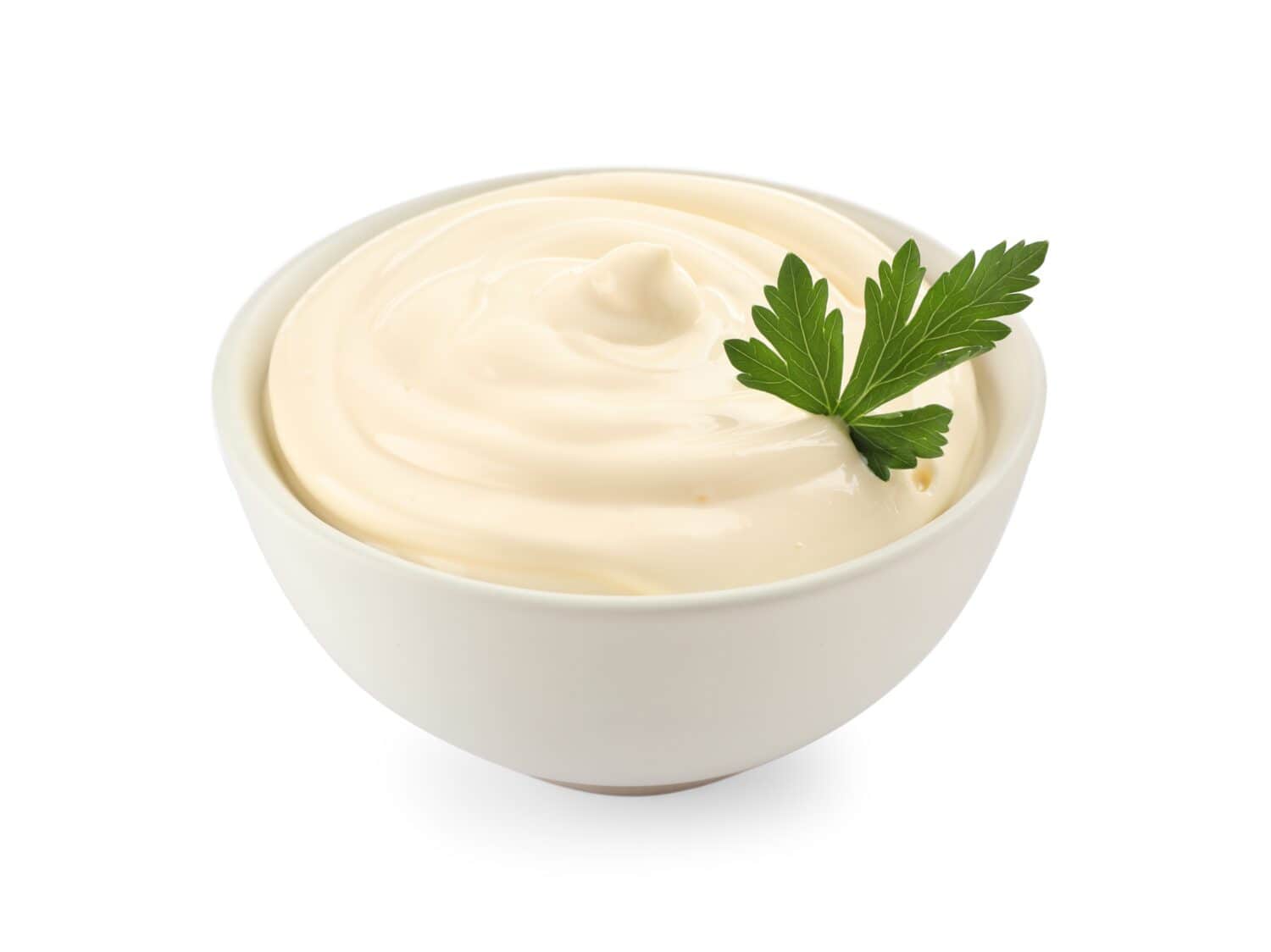 Bowl of tasty mayonnaise with parsley isolated on white