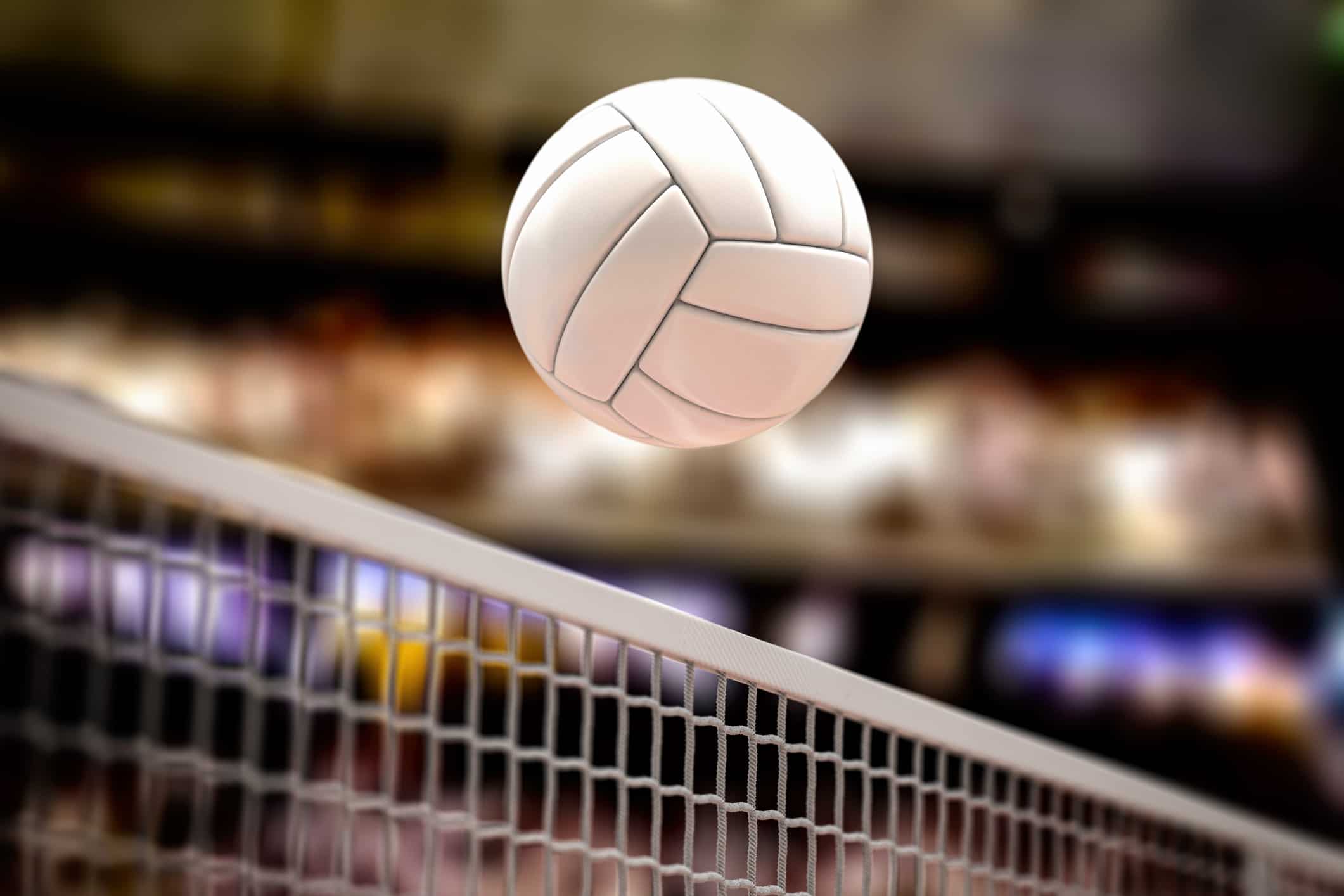 Volleyball ball and net in voleyball arena during a match.