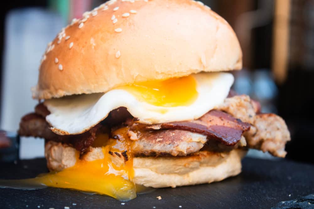 All day breakfast burger in a sesame bun with egg and bacon