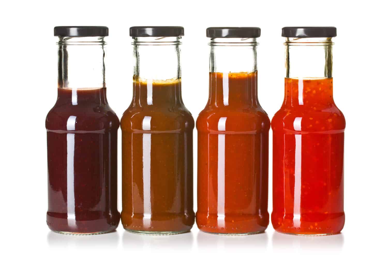 the various barbecue sauces in glass bottles