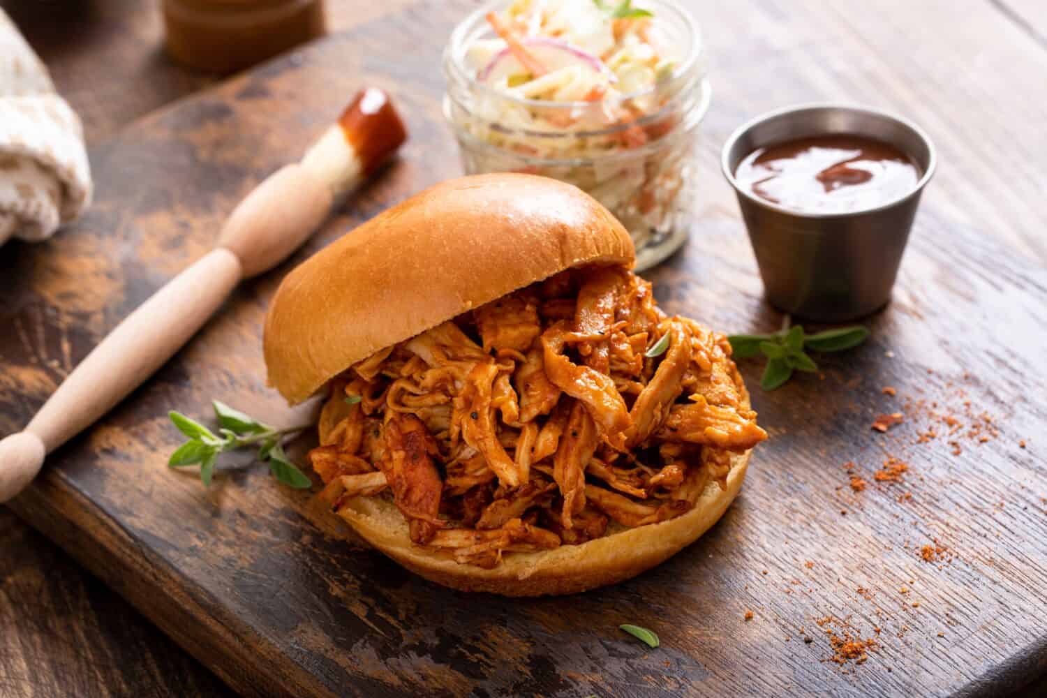 BBQ chicken sandwich on a brioche bun served with coleslaw