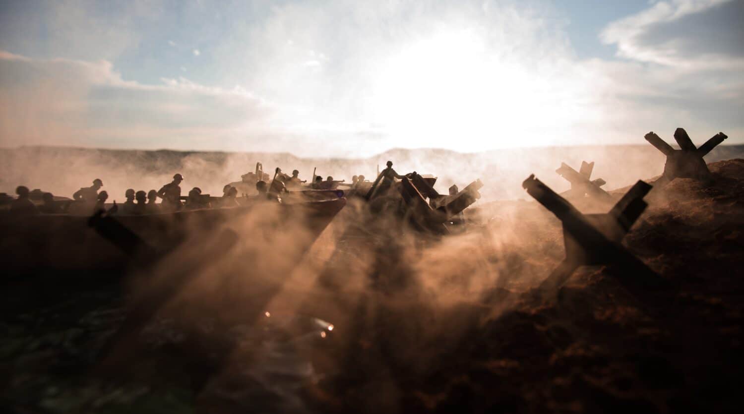 World War 2 reenactment (D-day). Creative decoration with toy soldiers, landing crafts and hedgehogs. Battle scene of Normandy landing on June 6, 1944. Selective focus