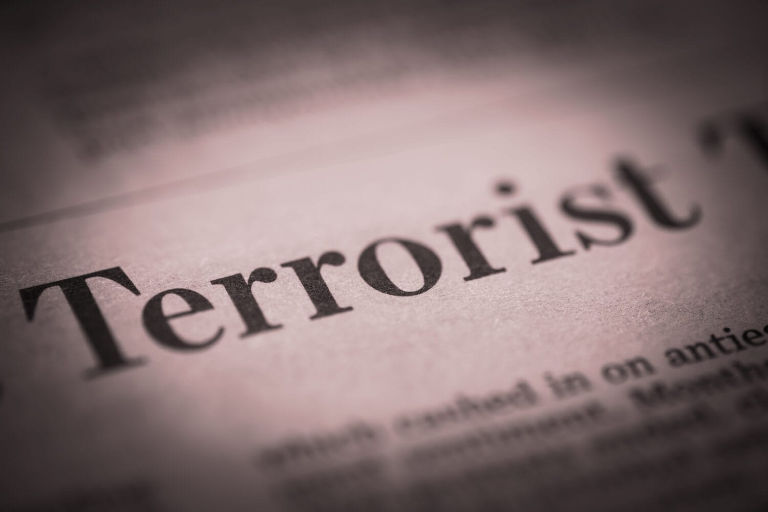 Terrorist written newspaper, shallow dof, real newspaper.