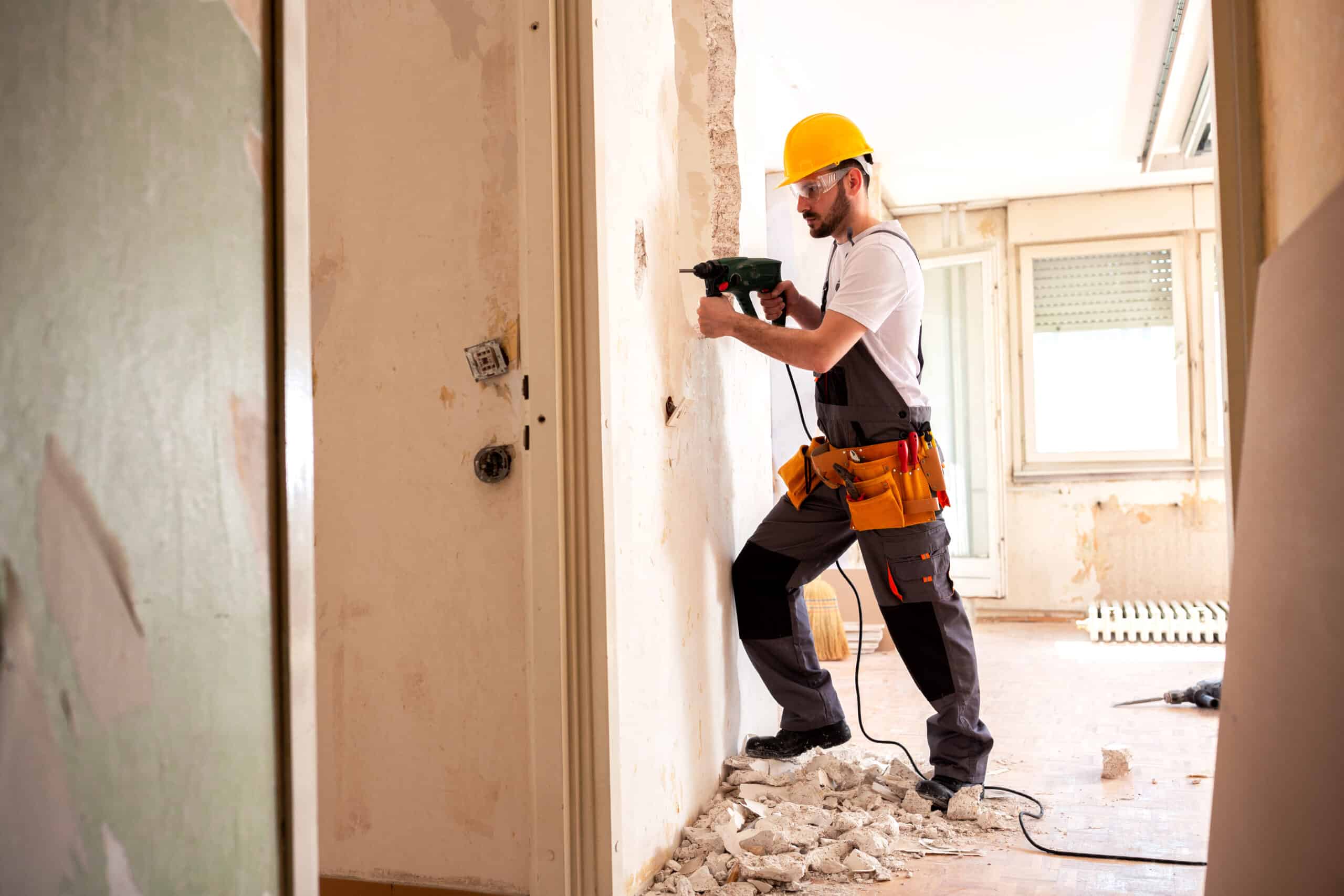 Experienced worker using hammer drill