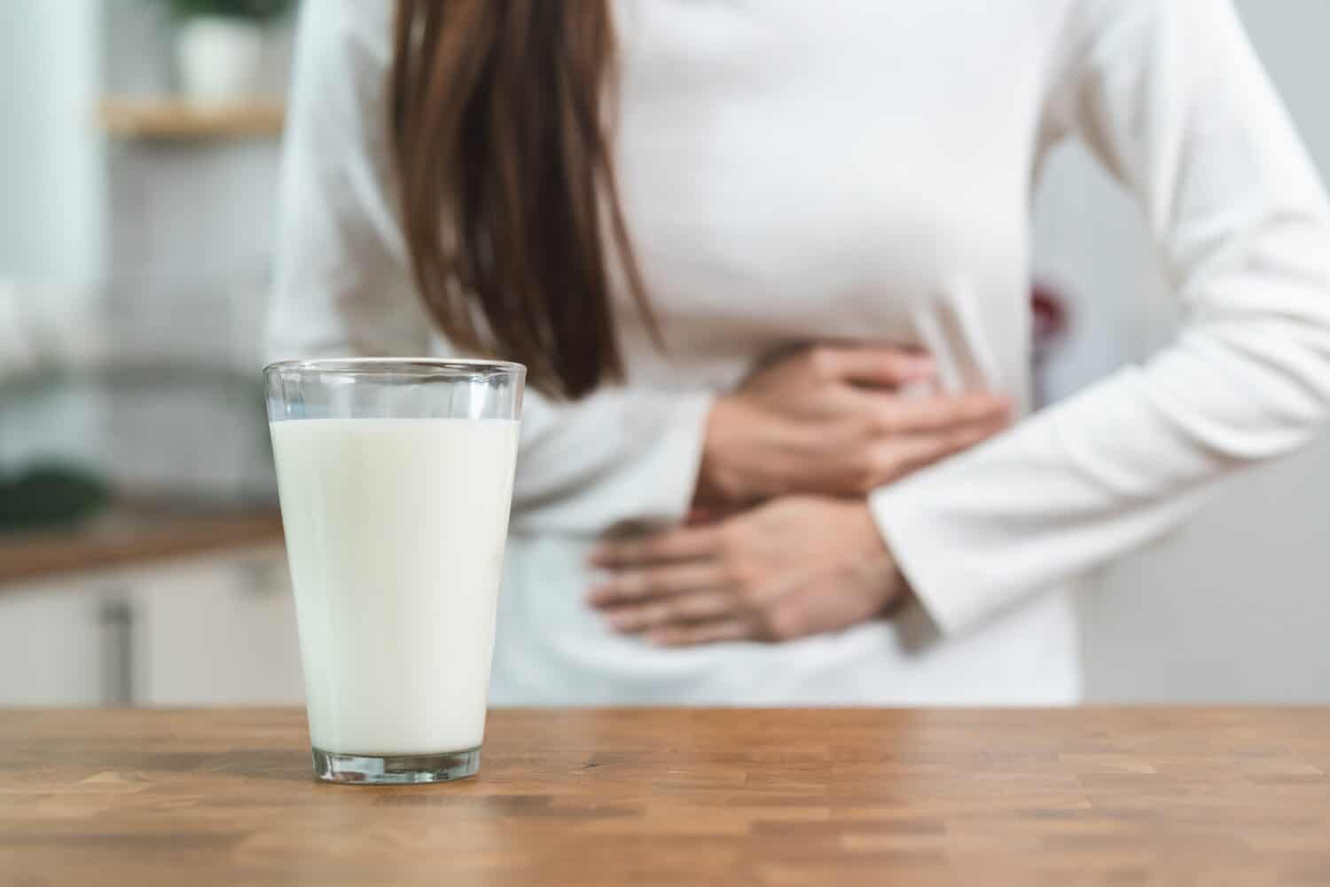 lactose intolerance concept. Woman having a stomach ache from lactose intolerance.