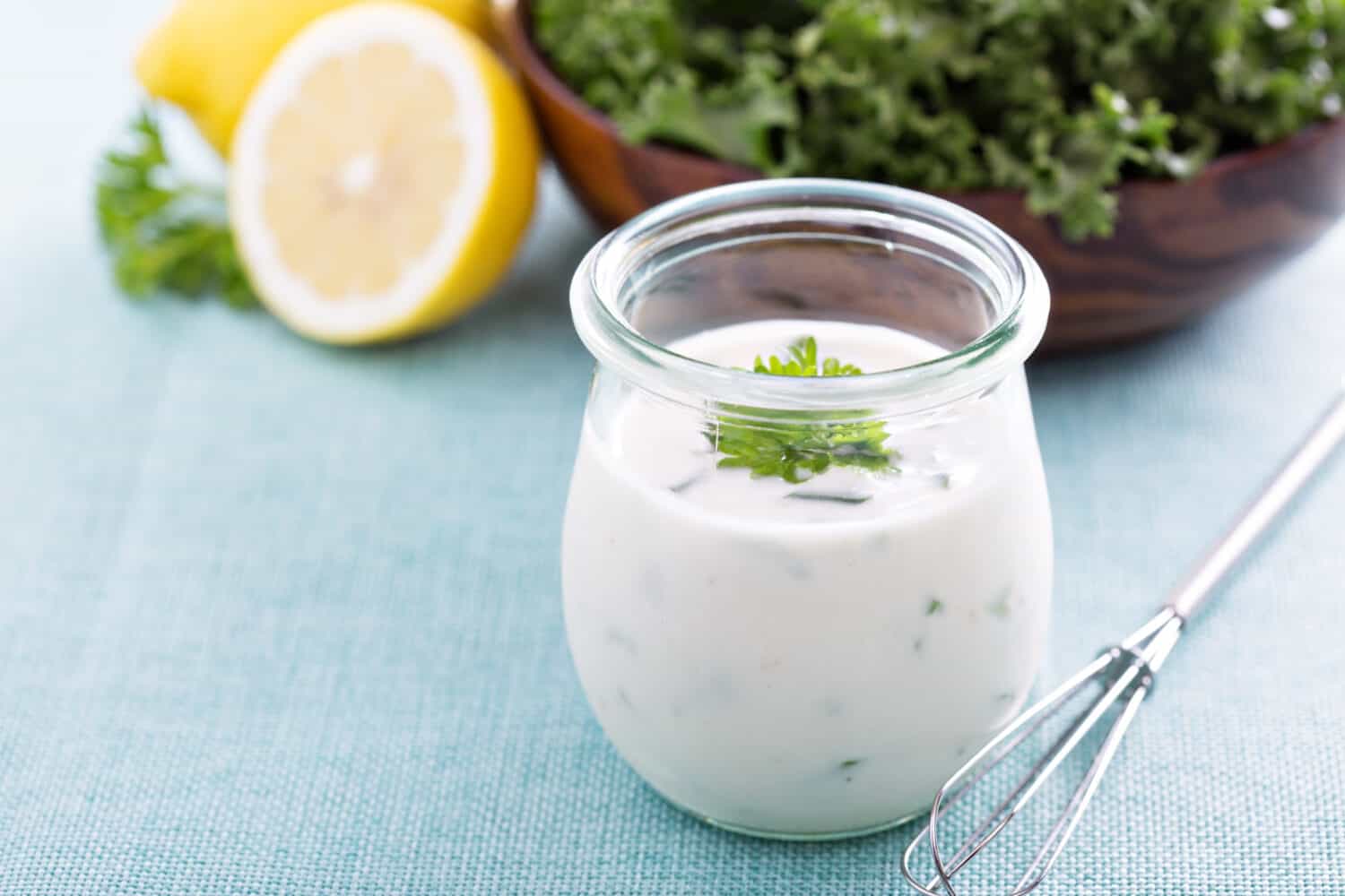 Homemade ranch dressing in a small jar with herbs