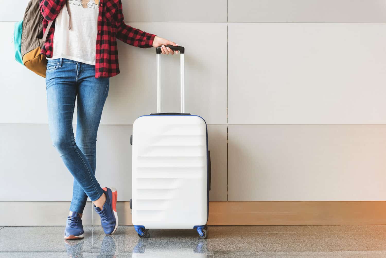 Young woman wearing casual clothes is posing at airport