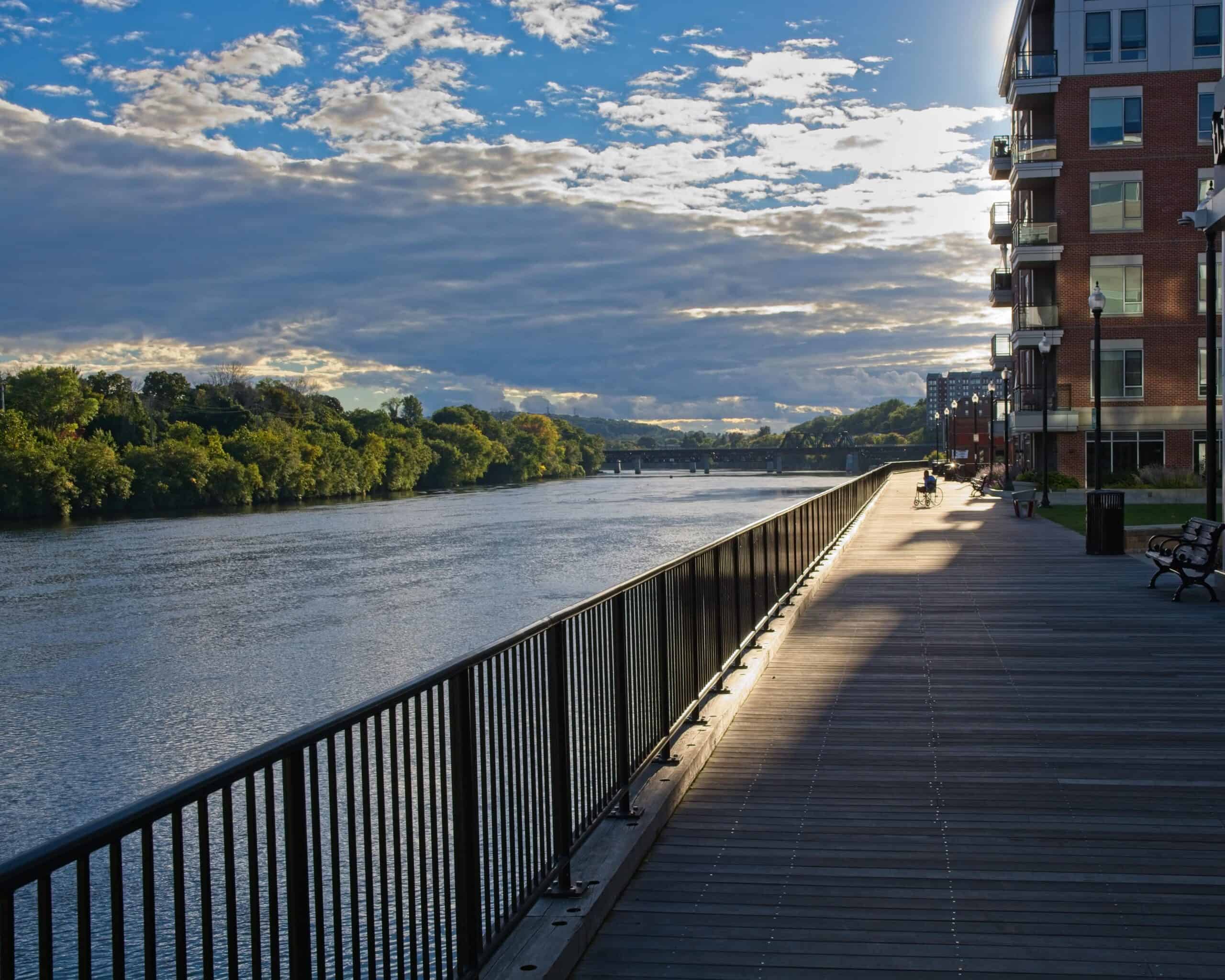 Haverhill, Massachusetts | Wheelchair user on Wall street boardwalk at banks of Merrimack river in Haverhill