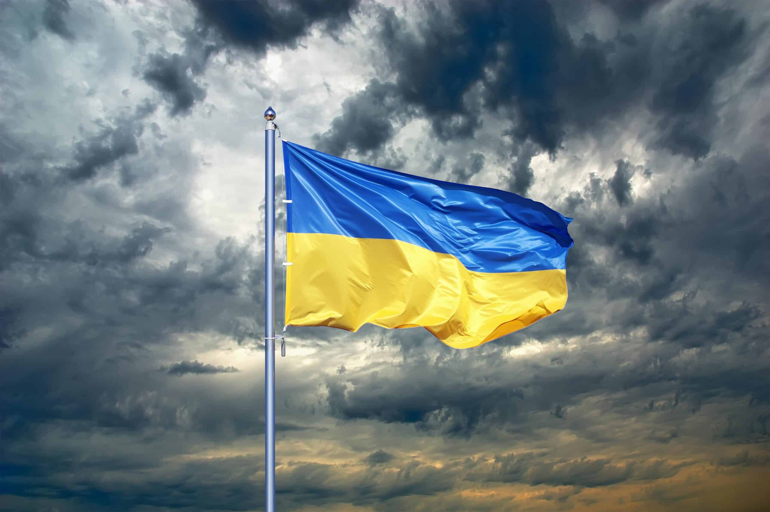 Ukraine | Ukraine flag. Ukrainian flag on black storm cloud sky. stormy weather