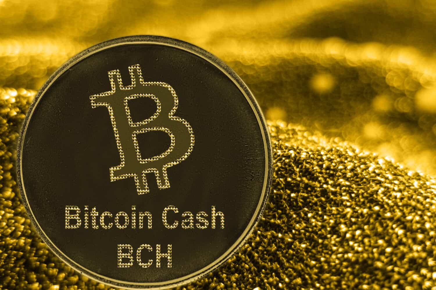 Coin cryptocurrency BCH and gold fabric background. Bitcoin cash logo.