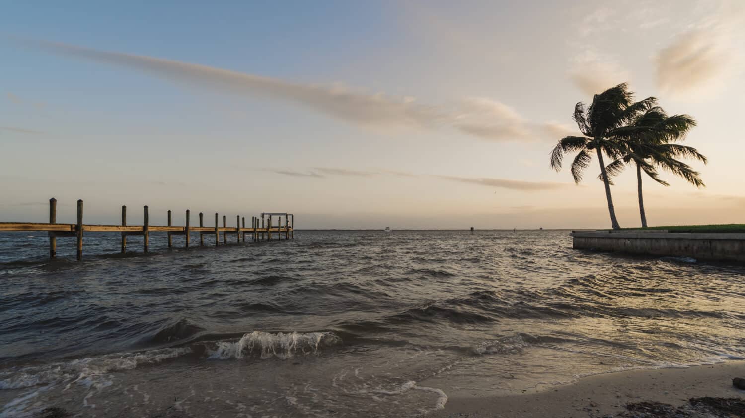 Sunset on Pine Island, Florida with a dock and palm trees