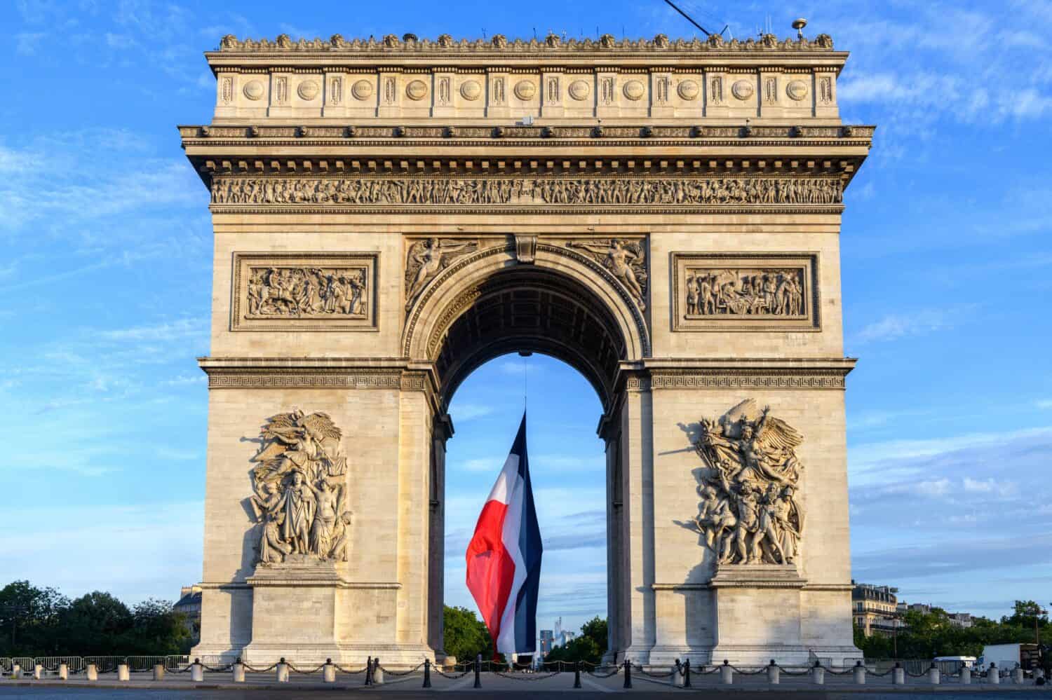 Early in the morning, the French flag is installed on the Arc de Triomphe for the Bastille Day parade.