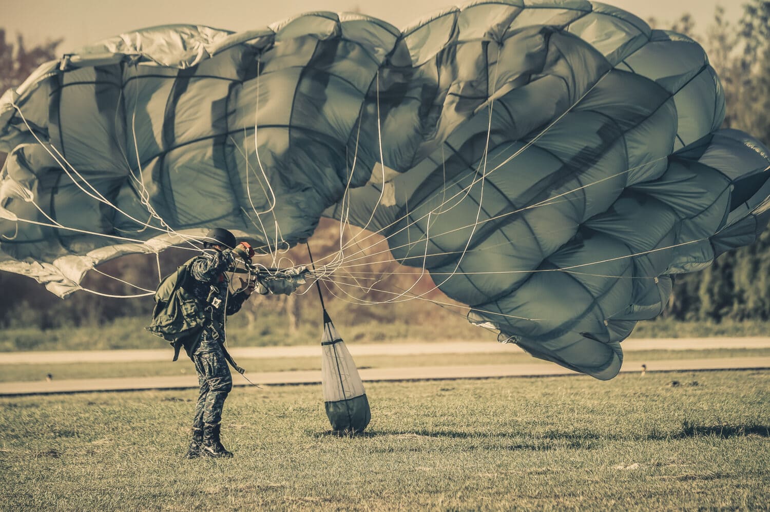 Parachute Attack Airborne , US Army paratroopers , Member of Red Star history club wears historical American paratrooper uniform during historical reenactment of WWII