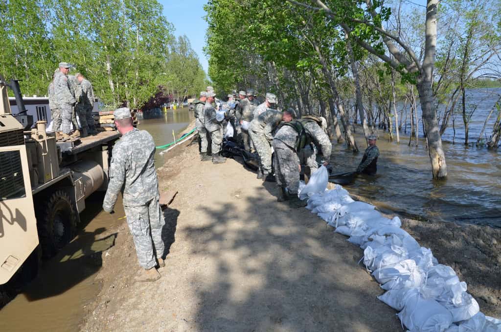 File:North Dakota National Guard soldiers place poly over temporary emergency levees (1).jpg by US Army Corps of Engineers from USA