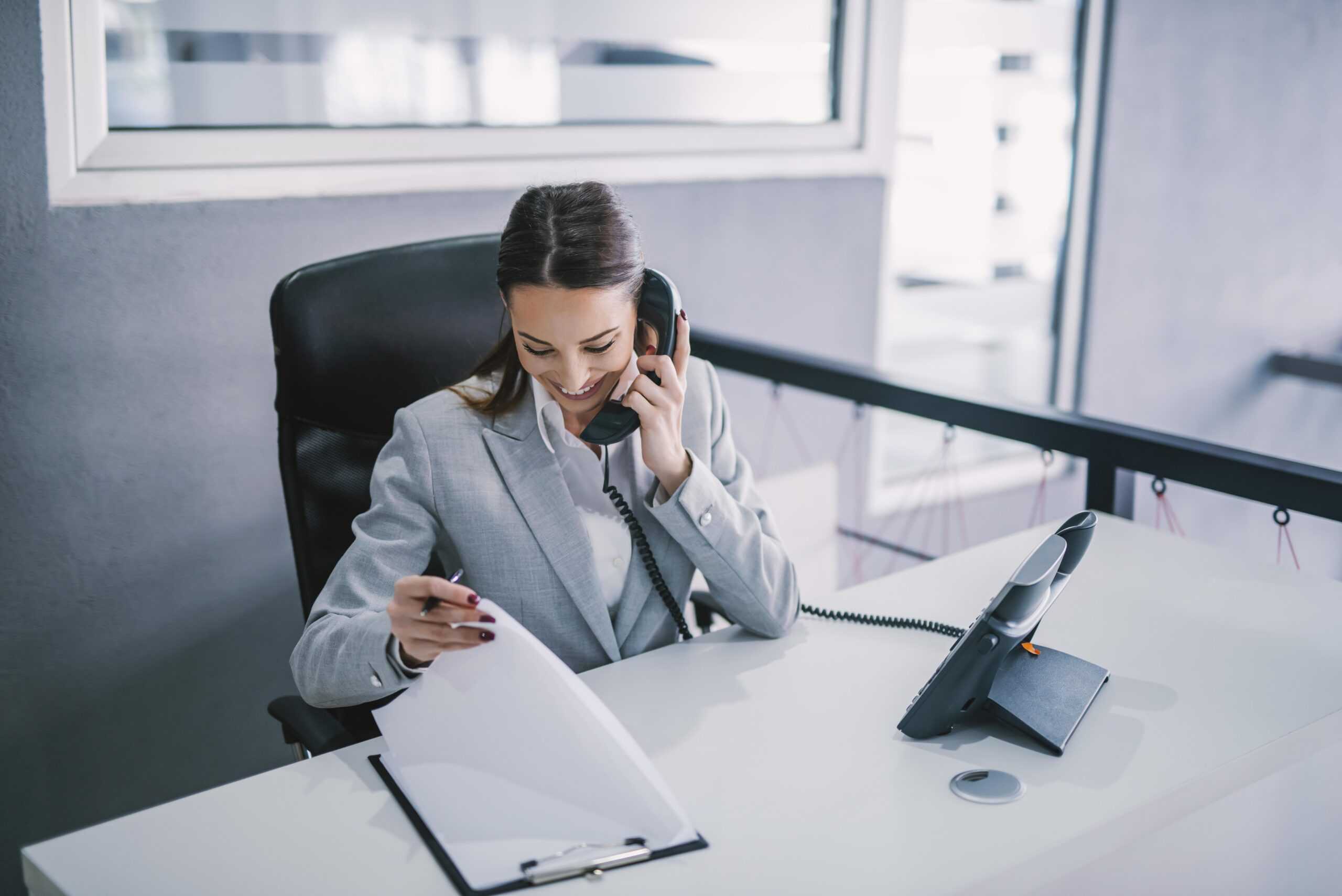 Secretaries and administrative assistants, except legal, medical, and executive workers | An assistant schedules a meeting on the phone at modern office.