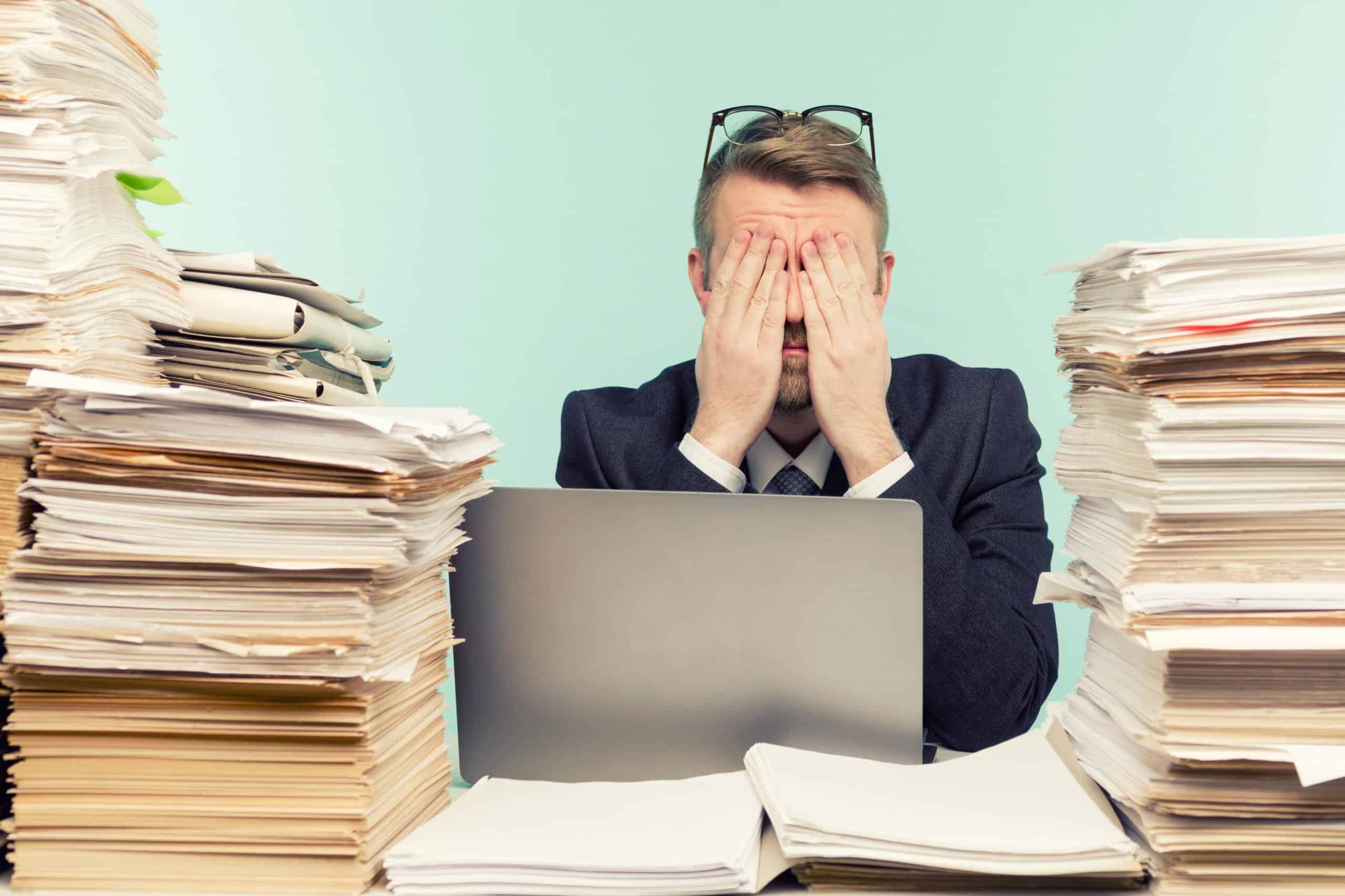 Bookkeeping, accounting, and auditing clerks workers | Close-up image of a stressful businessman tired from his work on the foreground