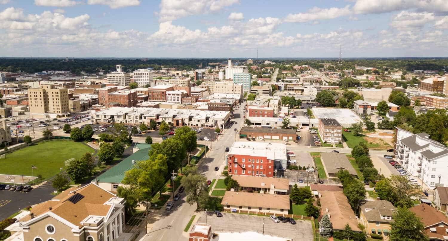 The downtown city skyline and buidlings of Sprigfield MO under partly cloudy skies aerial perspective by Real Window Creative