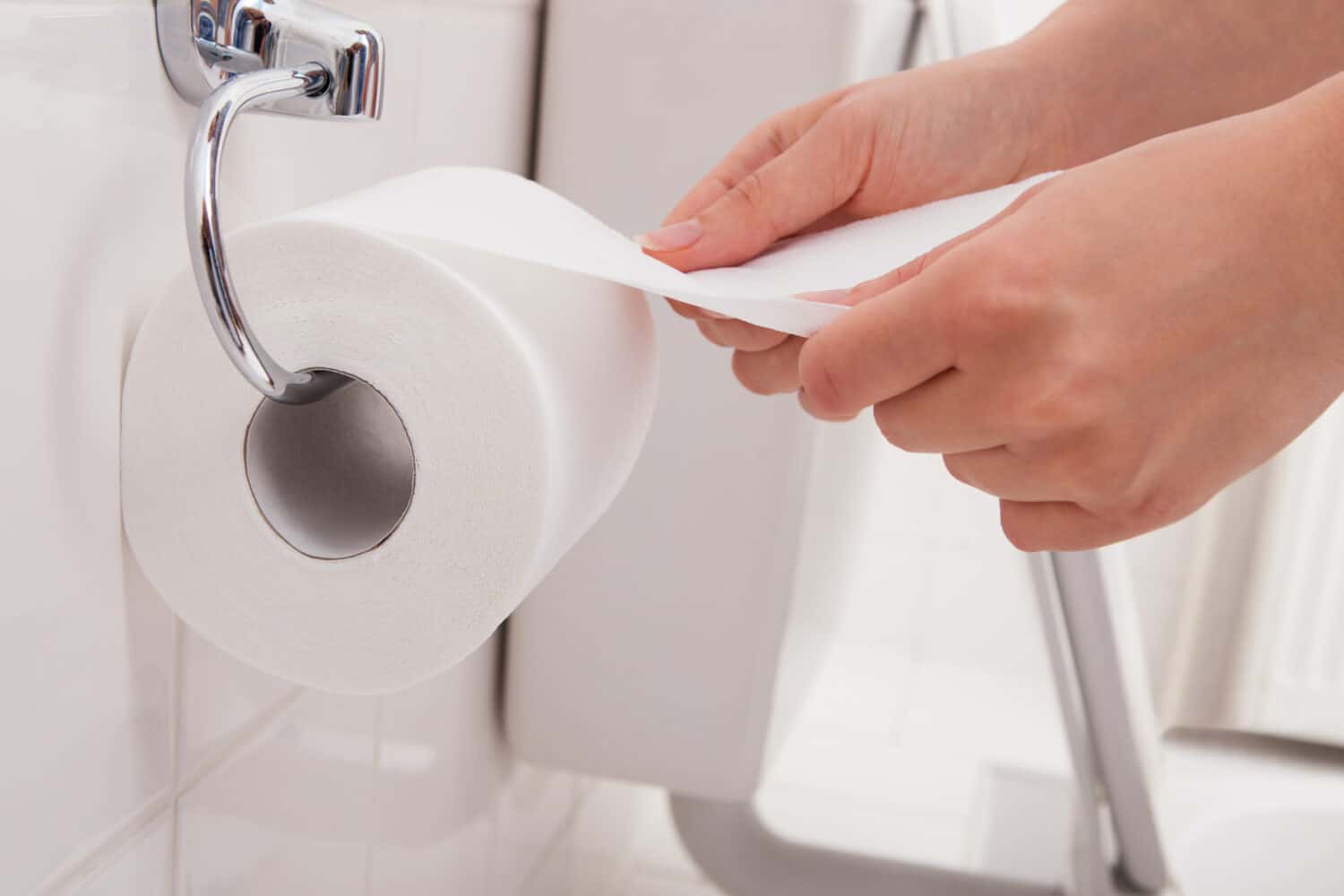 Close-up Of A Person&#039;s Hand Using Toilet Paper