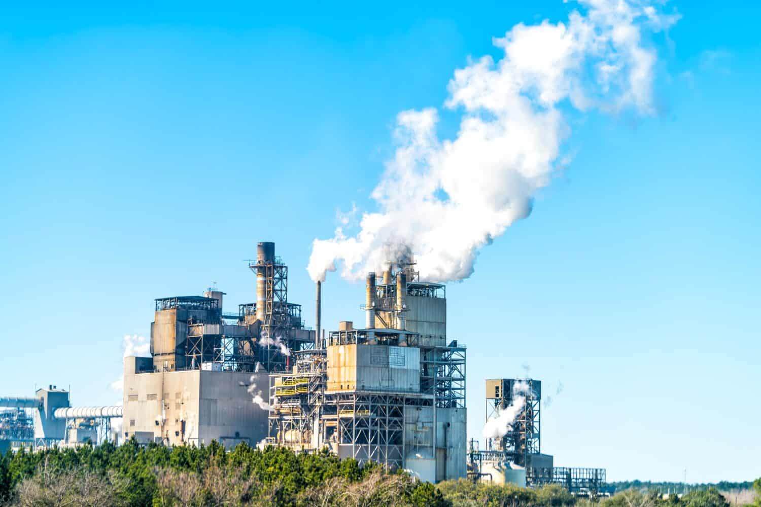 Industrial paper mill factory plant with chimney smokestacks stacks emitting carbon dioxide emission pollution in Georgetown, South Carolina town