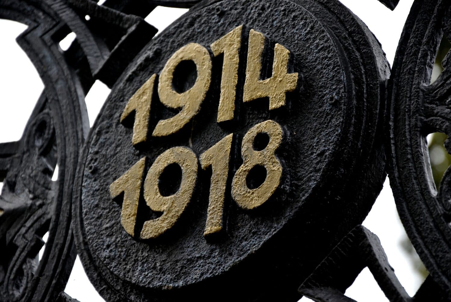 gilded cross of fallen fighters in the First World War. 1914 and 1918. Circular die-cast metal emblem. renovation of historical war graves with painted paint. Austria-Hungary, graveyard, number