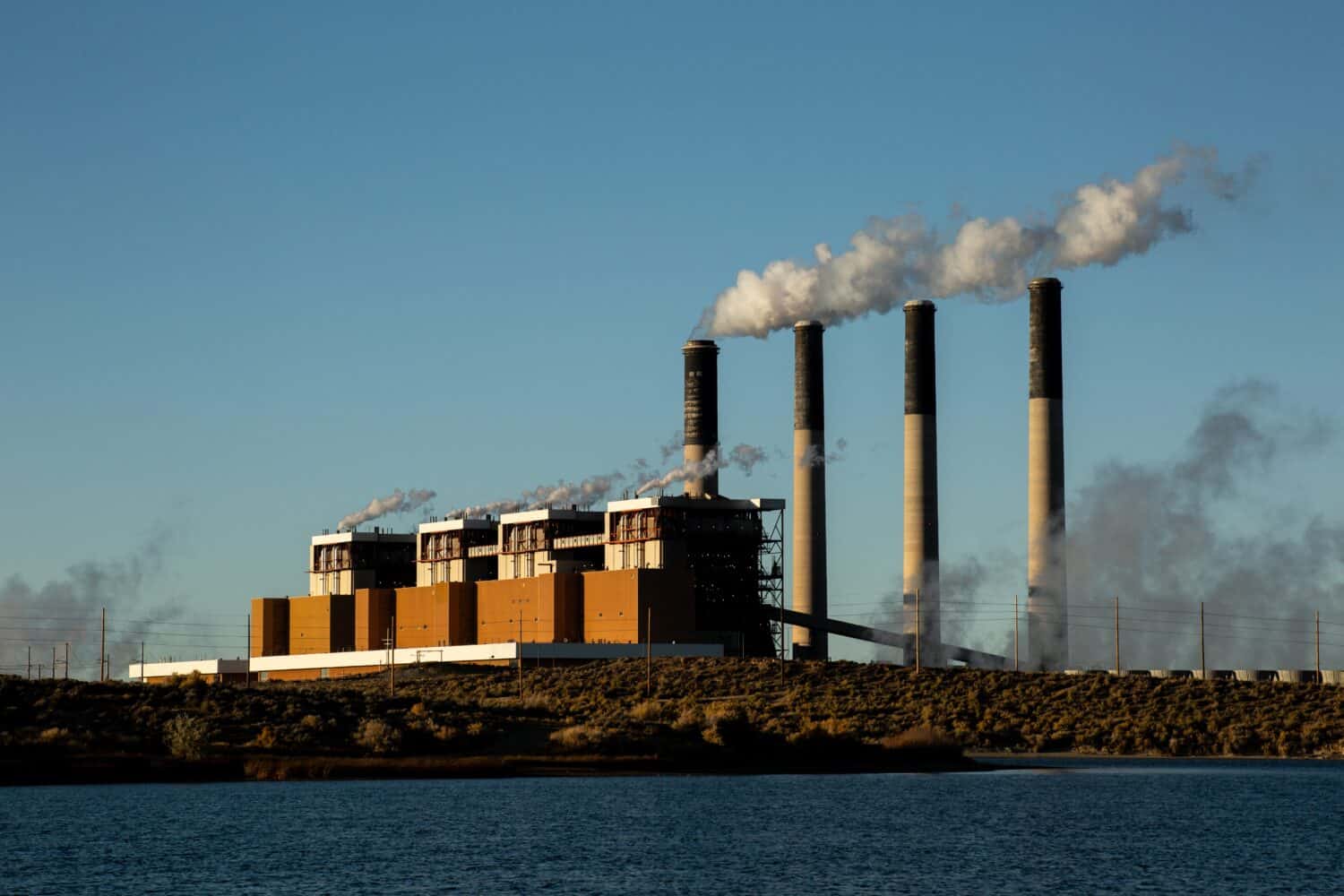 Jim Bridger Power Plant at Sunset with Steam coming from smokestacks at Point of Rocks Wyoming