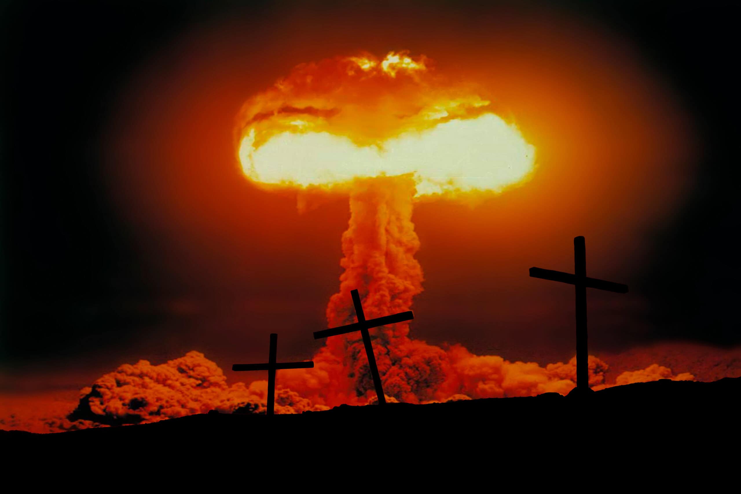 Nuclear explosion with mushroom cloud on the background of crosses. Nuclear war threat concept