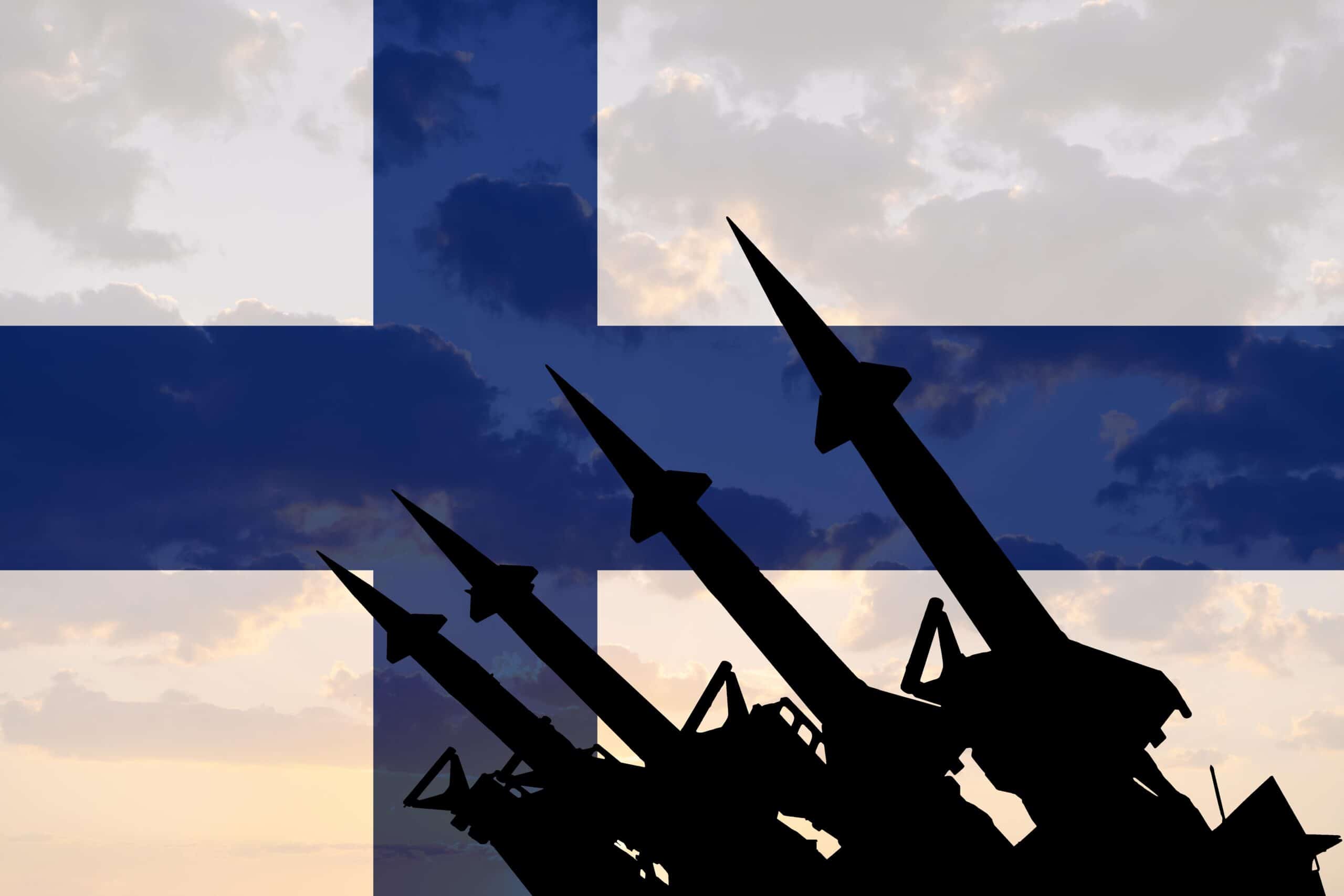 Finland artillery | Missile system on the background of the Finnish flag