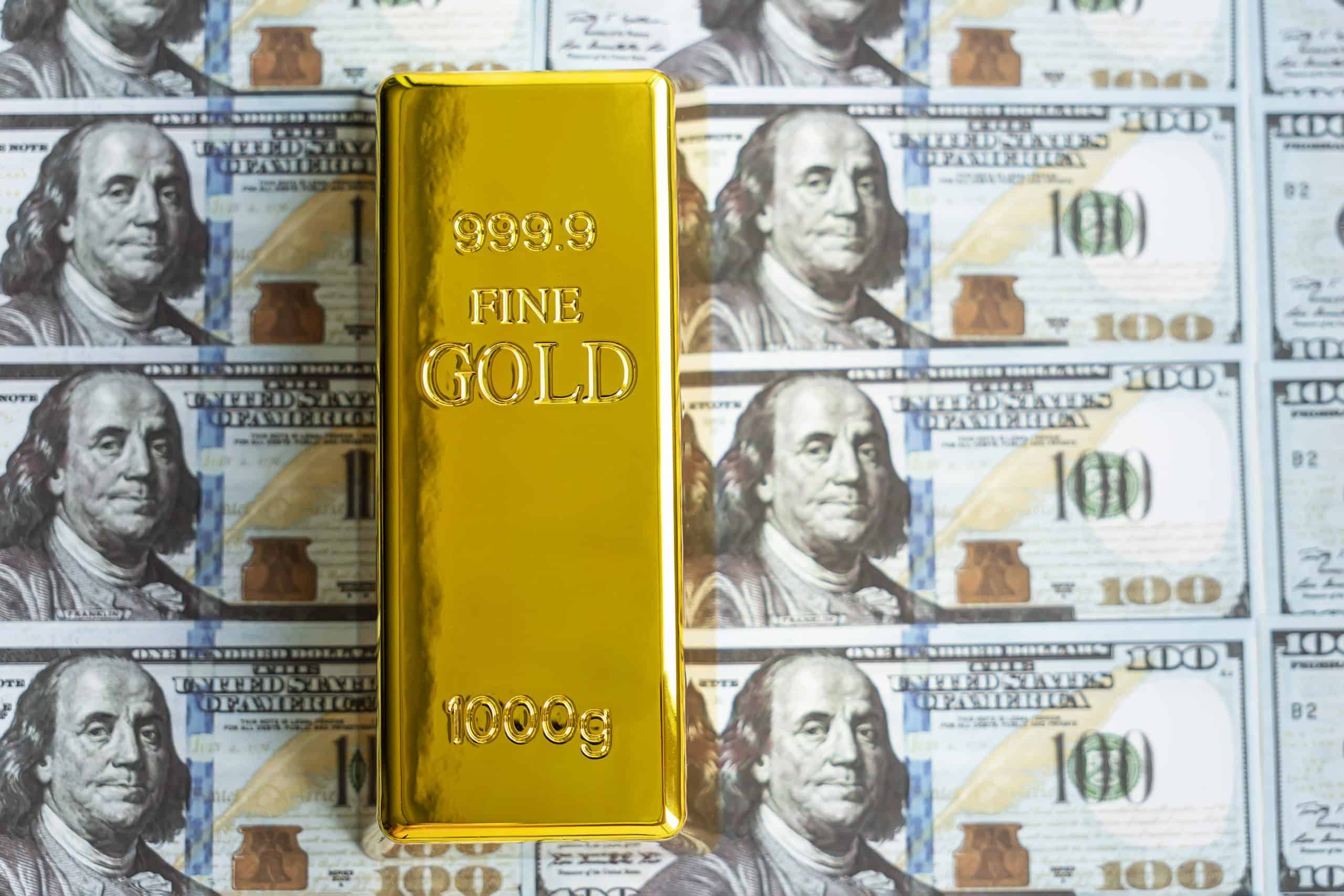 Gold reserves | Precious shiny gold bar on dollar bills. gold reserve of the United States of America