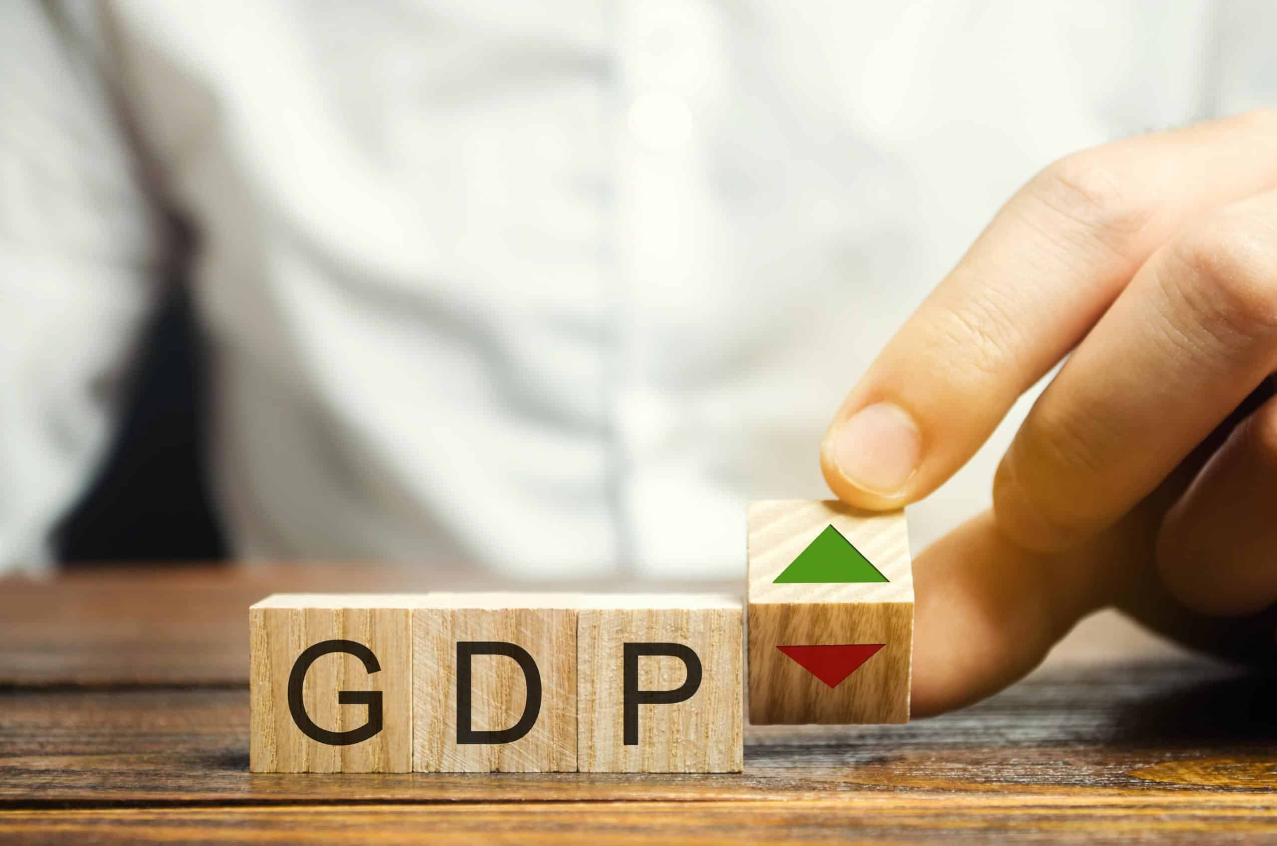 Gross domestic products | Wooden blocks with the word GDP and up and down arrows. An unstable economy in the country. Financial measure of the market value of all the final goods and services produced in a specific period.