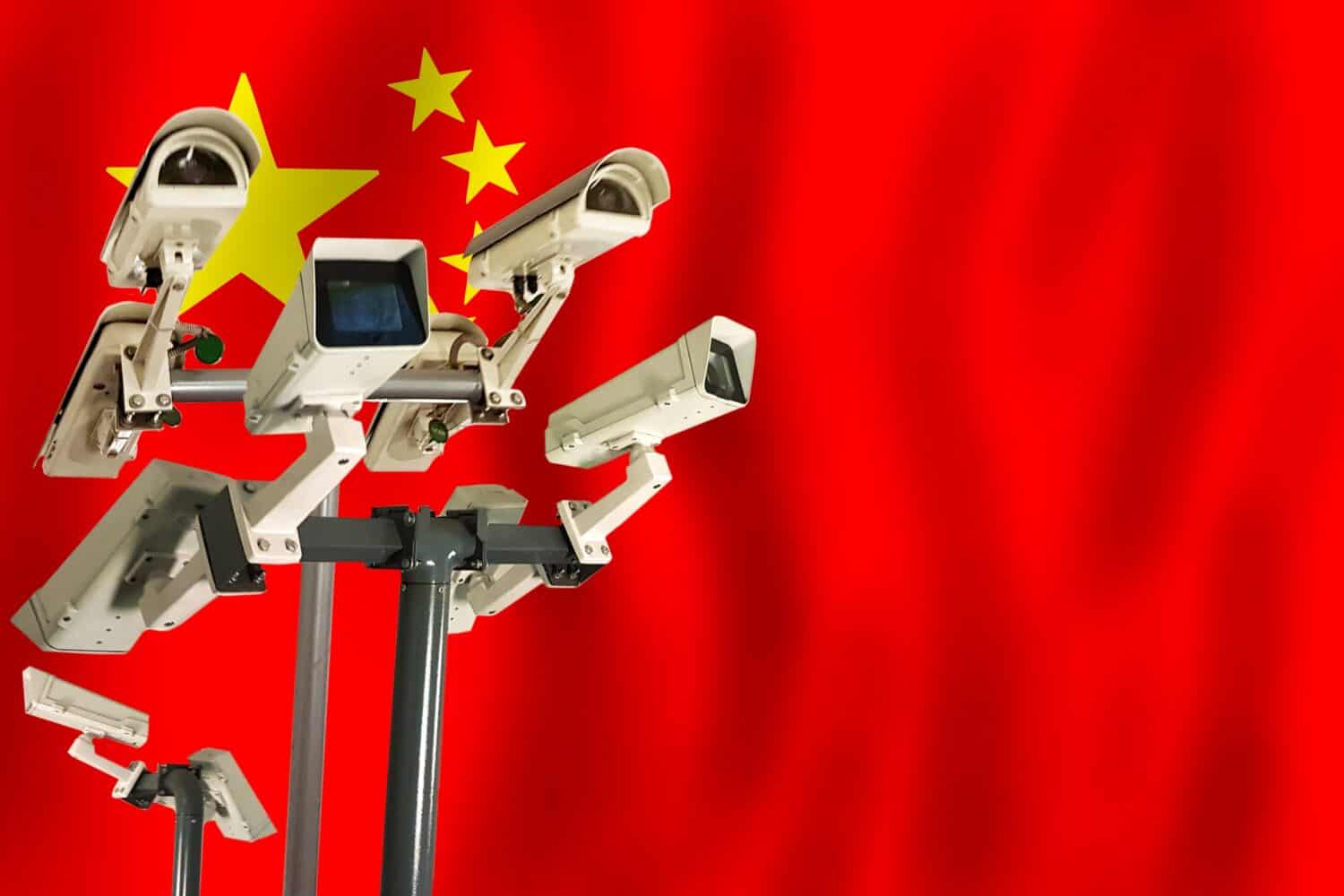 Chinese CCTV camera on the flag of China Surveillance, security, control and totalitarianism concept