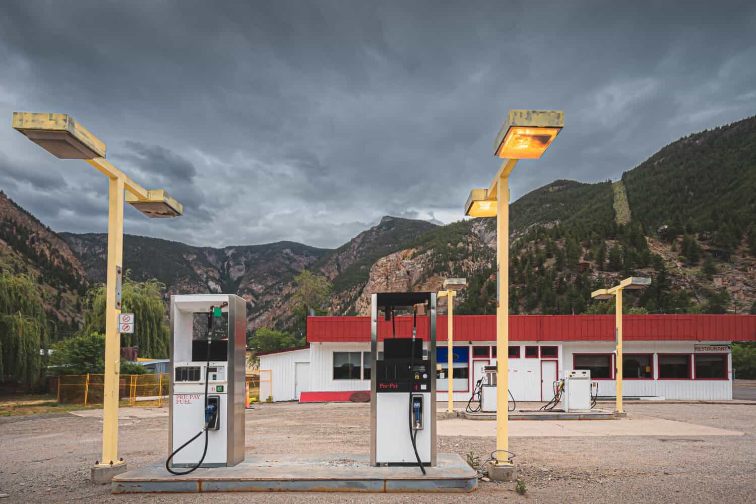 An old abandoned gas station rest stop in mining town Hedley, BC in the Okanagan against a dark moody sky.
