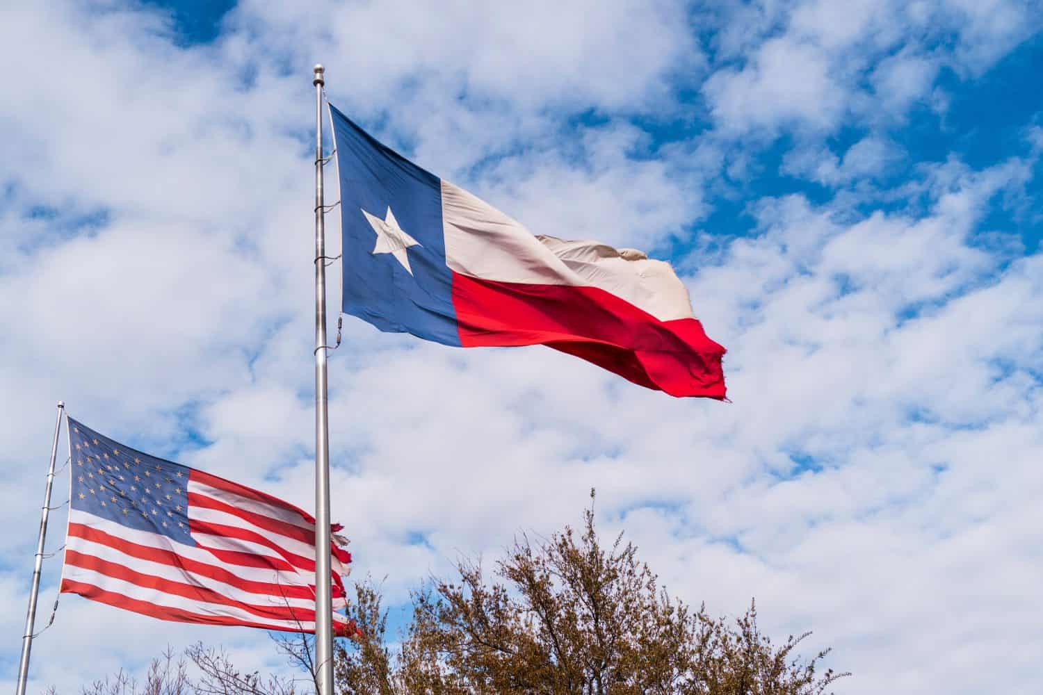 America Flag and Lone Star Texas State Flag waving in the wind over Midland, Texas