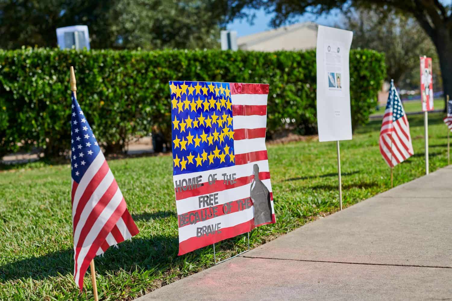 MISSOURI CITY, TEXAS, USA - November 10, 2017: Flags of the United States and patriotic posters drawn by students erected near Sienna Crossing Elementary school to celebrate Veterans Day