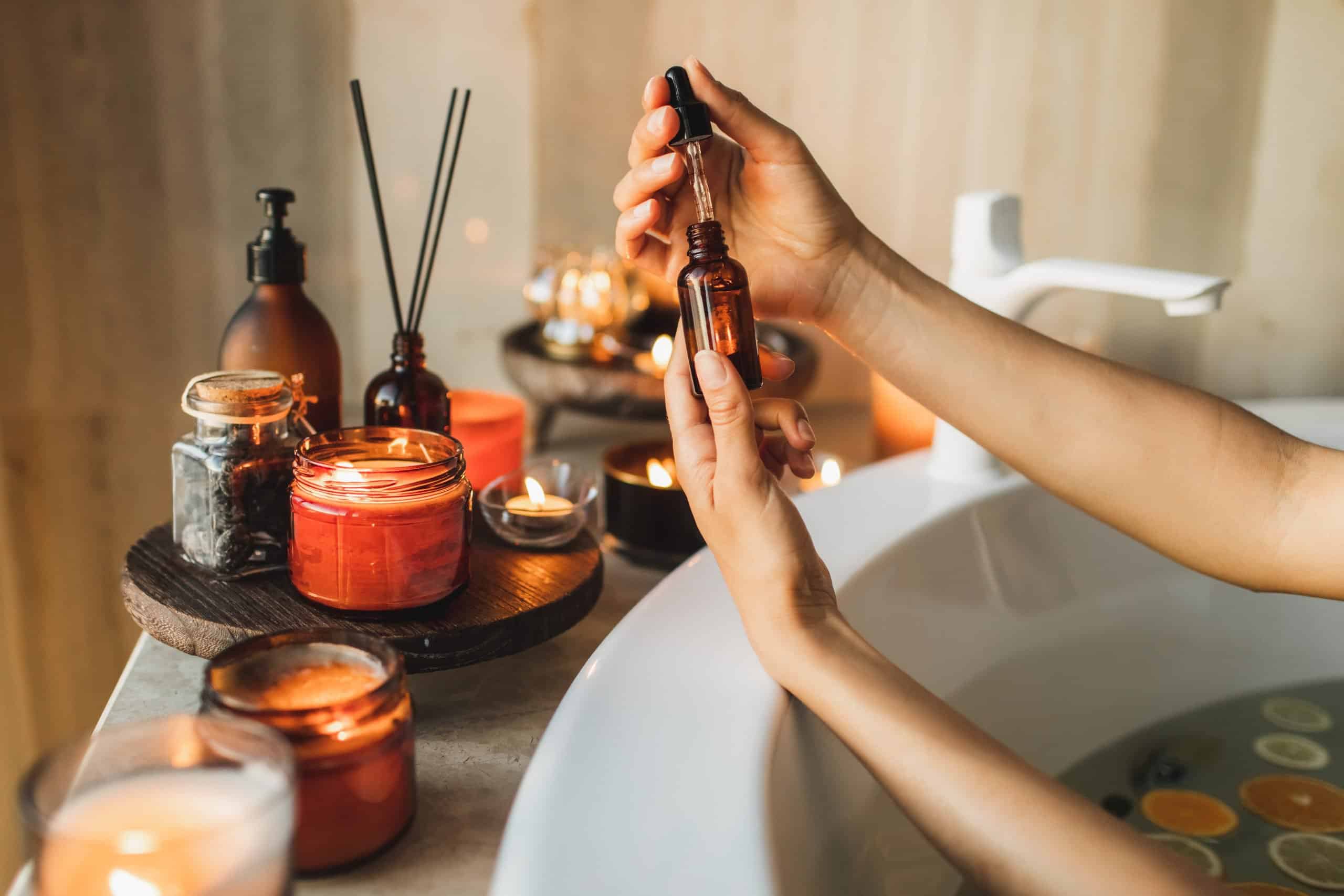 Woman&#039;s hands dropping collagen moisturizer into hands at home.