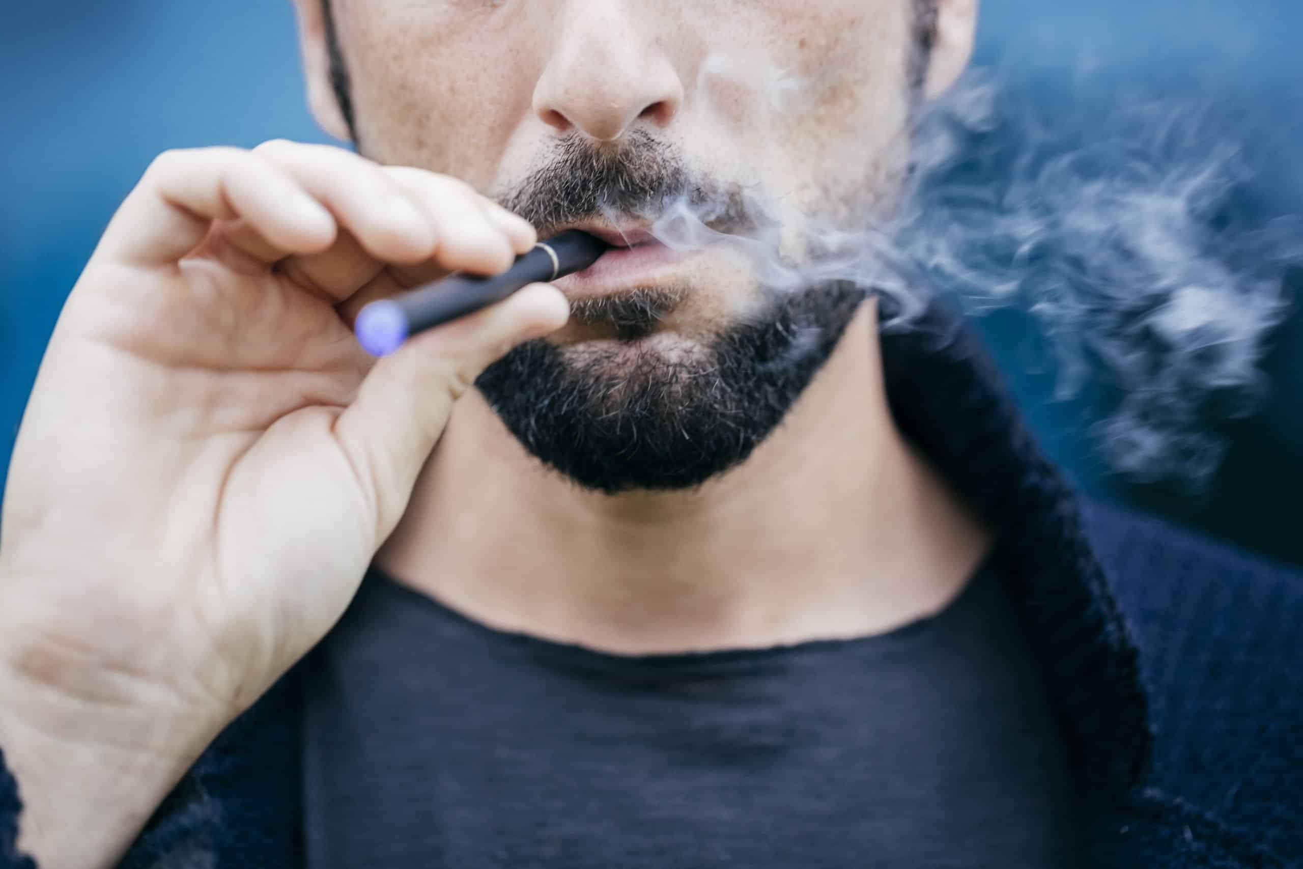 Portrait of man smoking an electronic cigarette