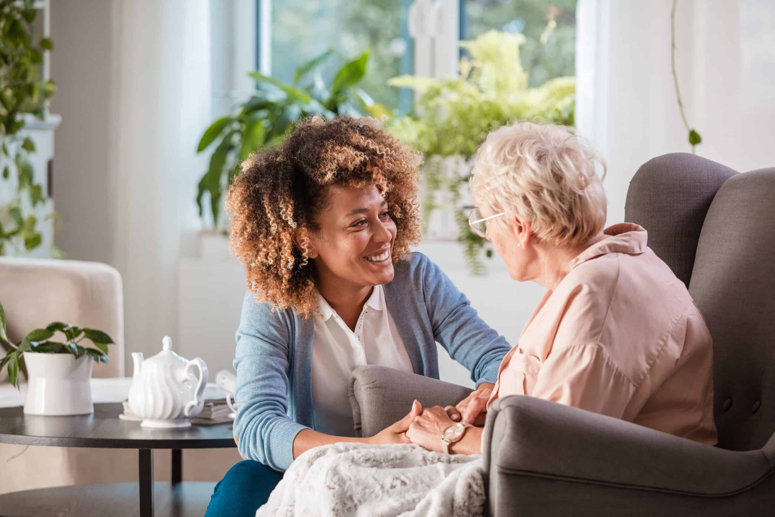 social assistance worker | Friendly nurse supporting an eldery lady