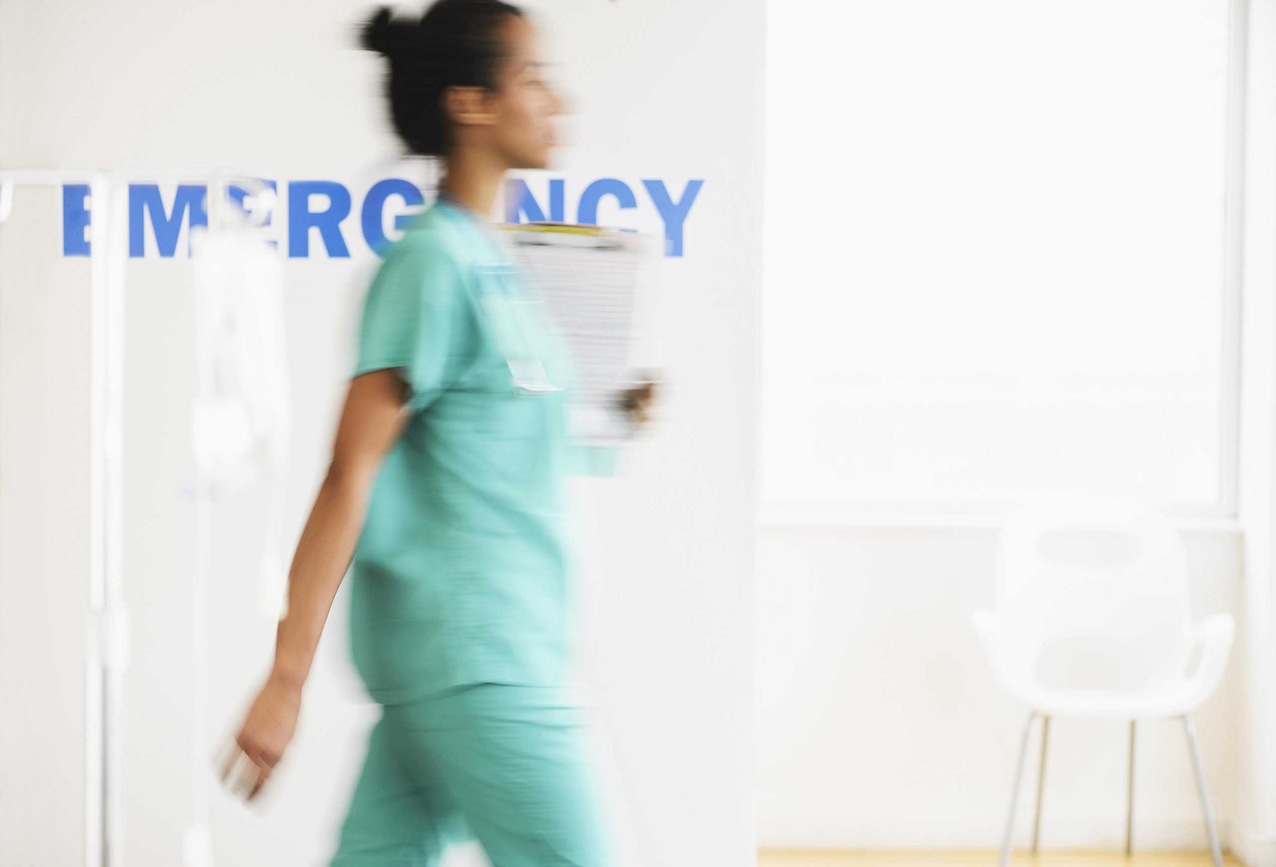 New Jersey hospital emergency | Mixed race nurse walking in hospital